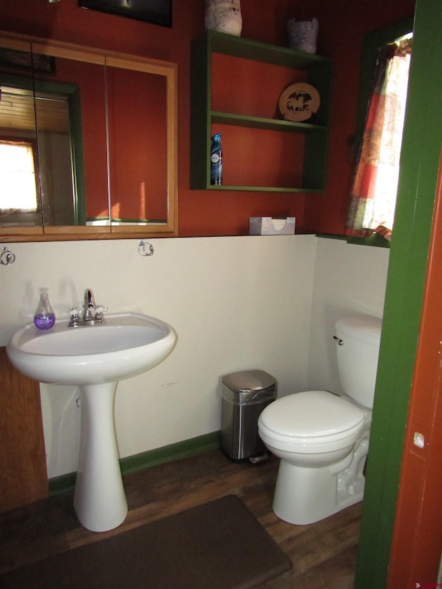 bathroom featuring hardwood / wood-style flooring and toilet