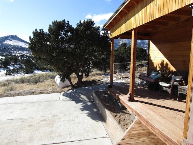 view of patio / terrace with a deck with mountain view