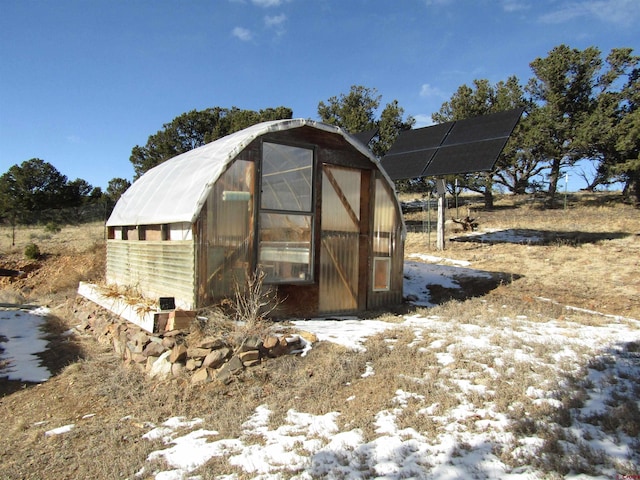 snow covered structure with solar panels