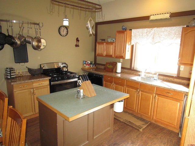 kitchen with stainless steel gas range oven, a center island, dark wood-type flooring, sink, and black dishwasher