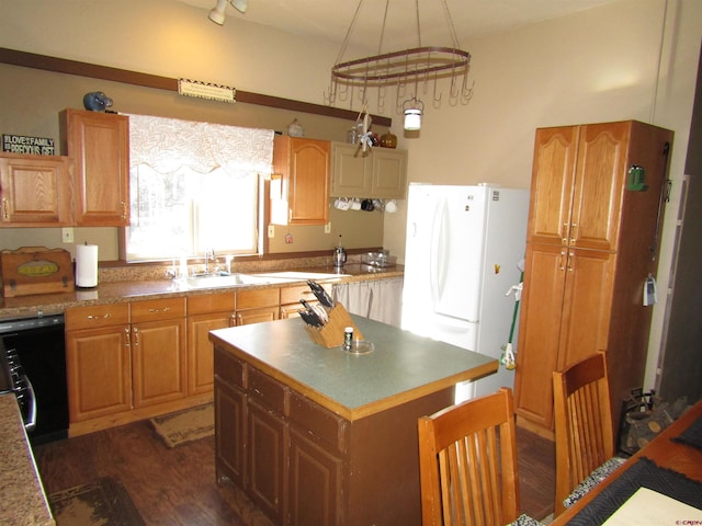 kitchen with dark wood-type flooring, dishwasher, a center island, white fridge, and hanging light fixtures