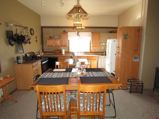 carpeted dining room with a notable chandelier