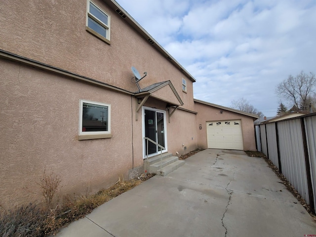 view of side of home featuring a garage