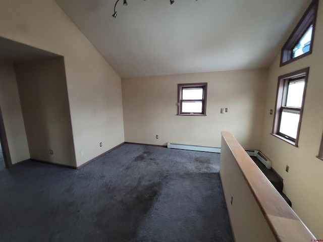 carpeted spare room featuring a baseboard radiator and vaulted ceiling