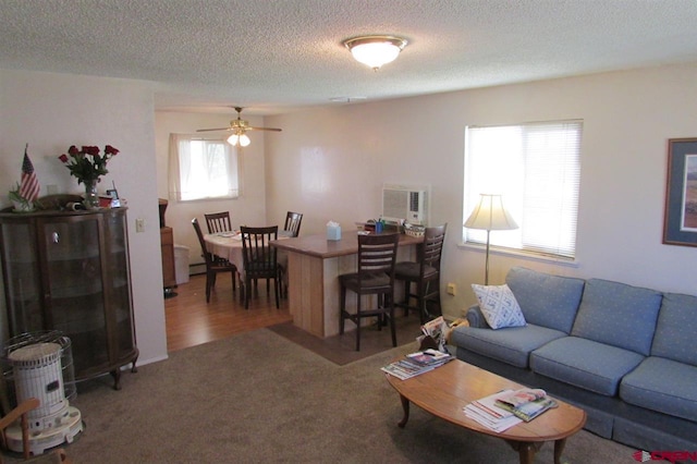 carpeted living room featuring a textured ceiling and ceiling fan