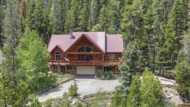 view of front of house featuring a garage and a wooden deck