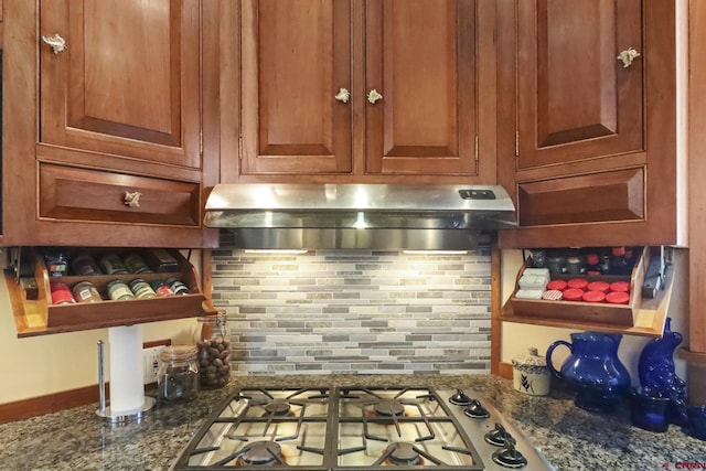 kitchen with stone counters, extractor fan, backsplash, and stainless steel gas cooktop