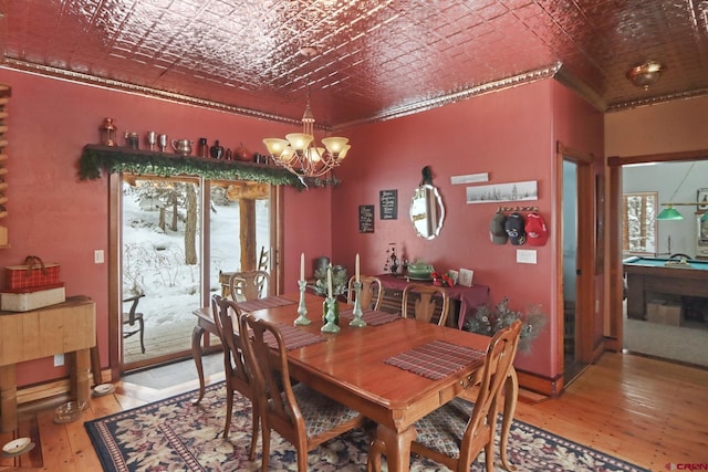 dining space featuring pool table, an inviting chandelier, crown molding, and wood-type flooring