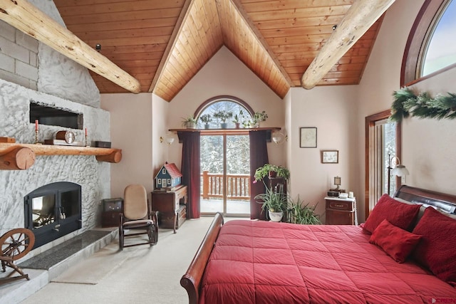 bedroom with wood ceiling, access to exterior, and a stone fireplace