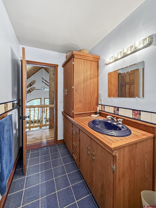 bathroom with lofted ceiling and vanity