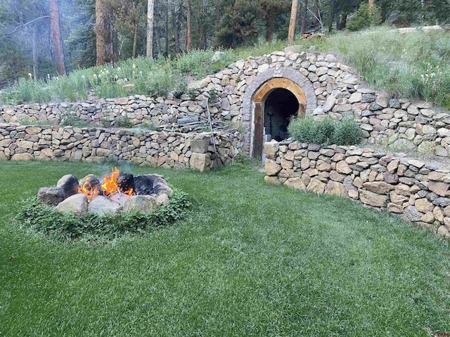 view of yard with an outdoor fire pit