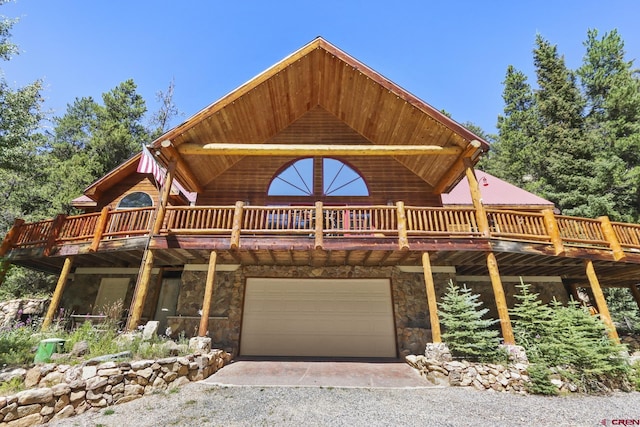 log cabin featuring a deck and a garage