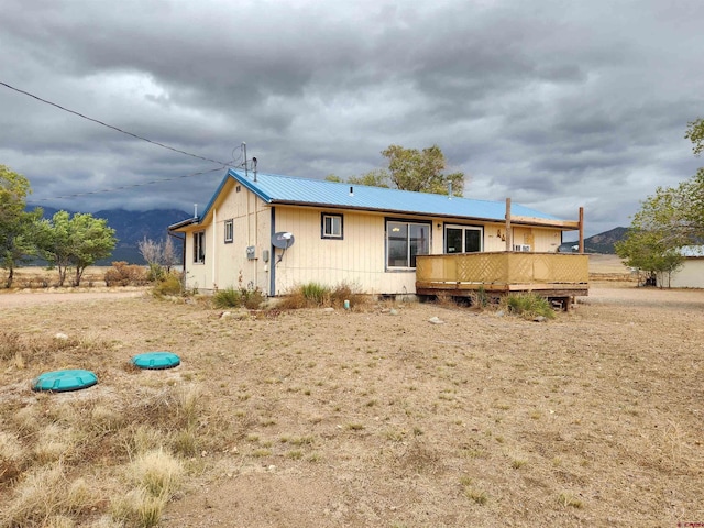 rear view of property with a wooden deck