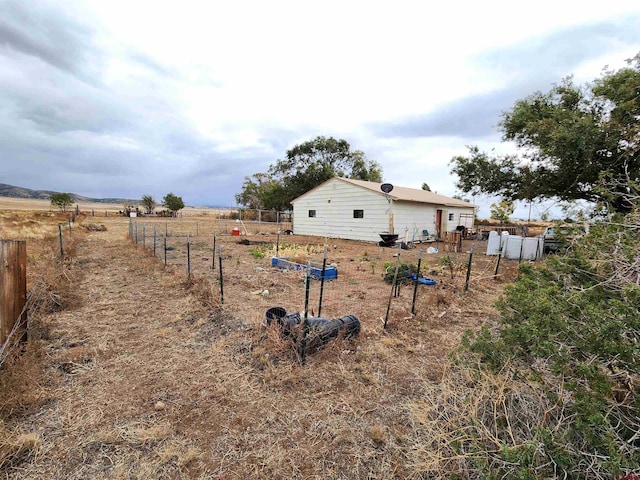 view of yard with a rural view