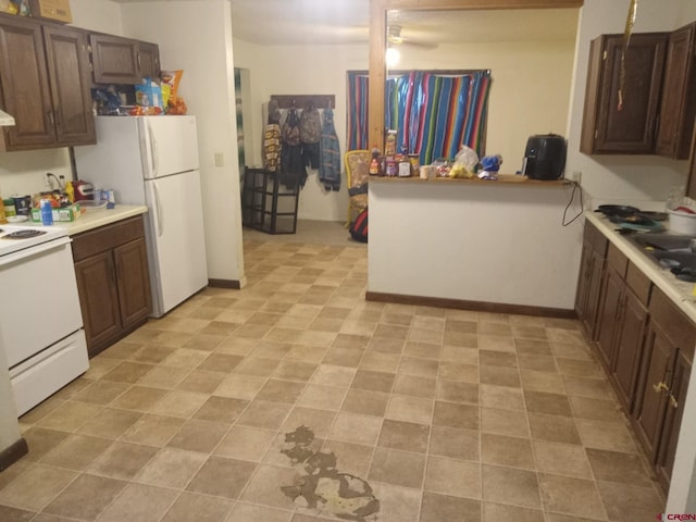 kitchen with white fridge, range, and dark brown cabinets