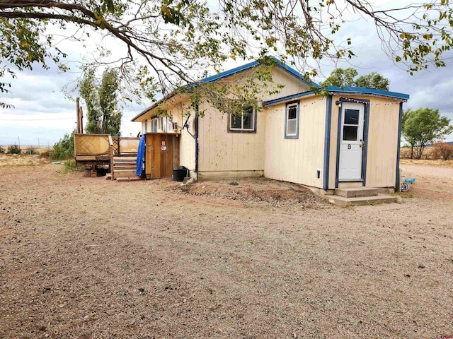 back of property featuring a wooden deck