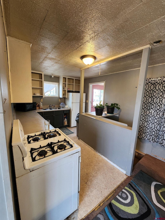 kitchen featuring white appliances and sink