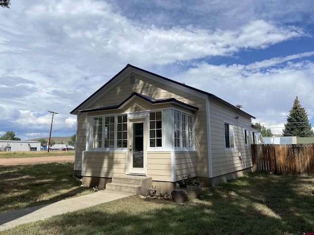 bungalow-style house with a front lawn