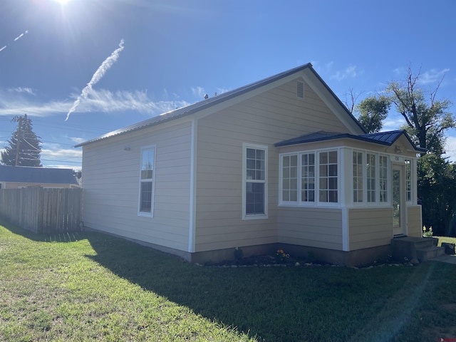 view of side of home with a lawn