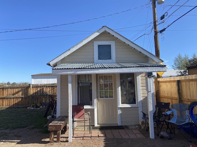 rear view of house with an outdoor structure