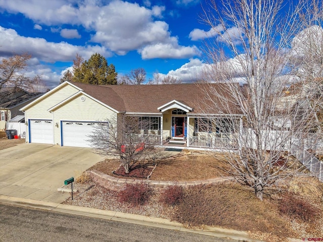 ranch-style house featuring a garage and covered porch