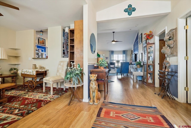 entrance foyer featuring ceiling fan, hardwood / wood-style floors, and lofted ceiling