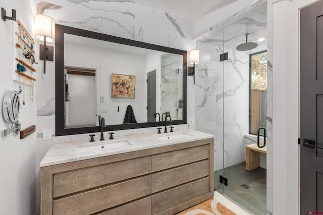 bathroom with tile walls, an enclosed shower, and vanity