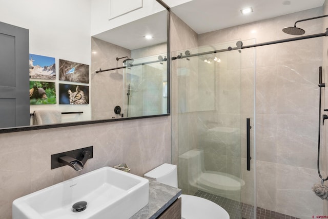 bathroom featuring toilet, an enclosed shower, and vanity