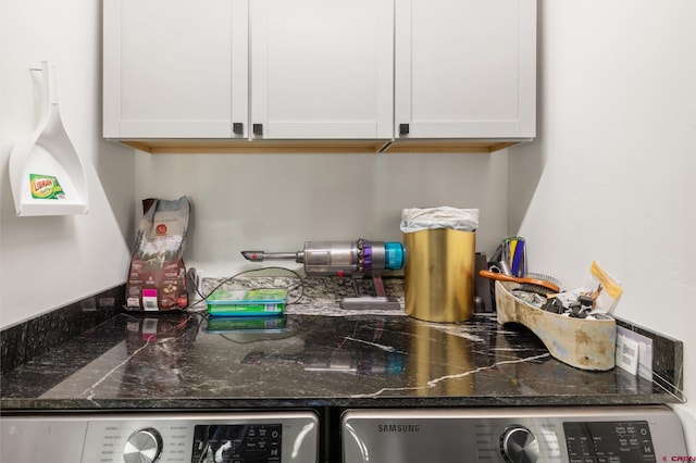 kitchen with washer and dryer, white cabinets, and dark stone countertops