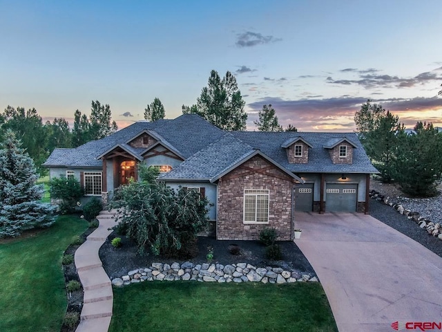 craftsman-style house with a garage and a lawn