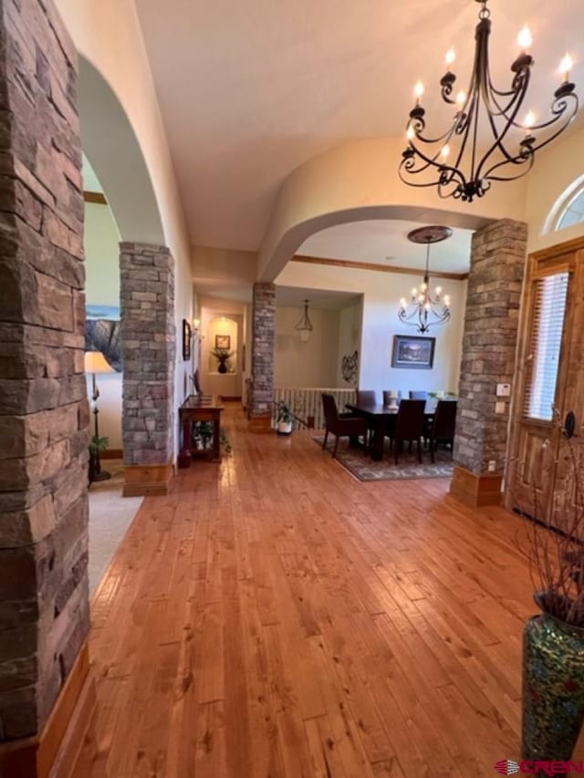 interior space featuring hardwood / wood-style flooring and a notable chandelier