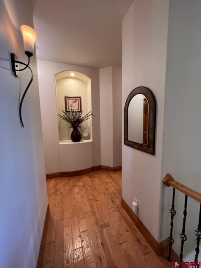 corridor with light hardwood / wood-style flooring