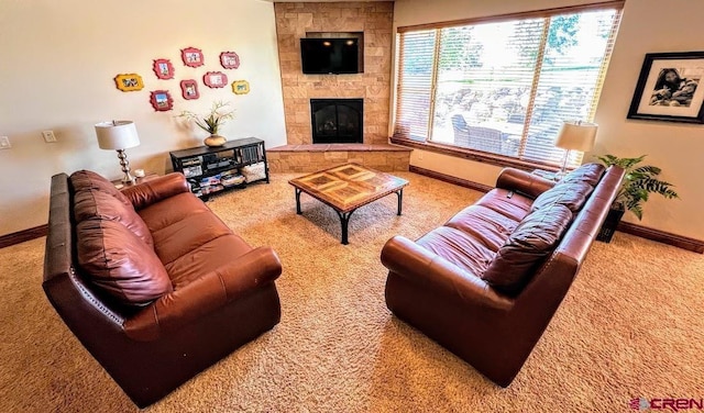 living room with a stone fireplace and carpet floors