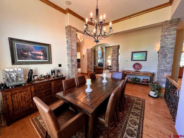 dining room with ornamental molding and light wood-type flooring