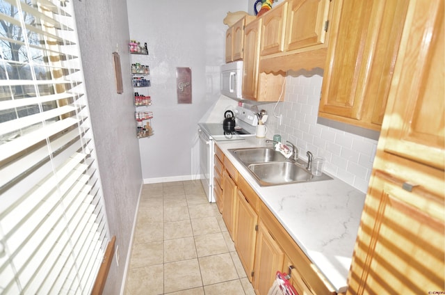 kitchen featuring sink, light tile patterned flooring, decorative backsplash, and electric range