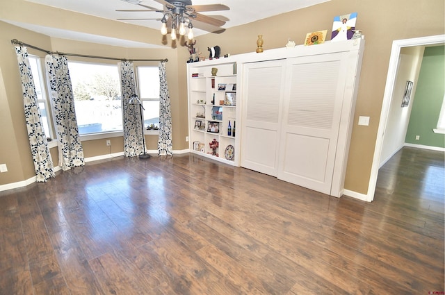 spare room with ceiling fan and dark hardwood / wood-style floors