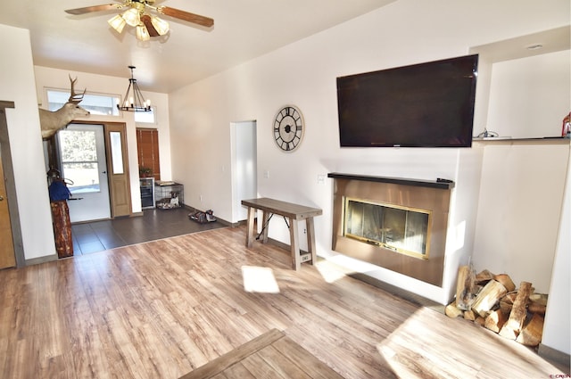 entryway featuring ceiling fan with notable chandelier and hardwood / wood-style flooring