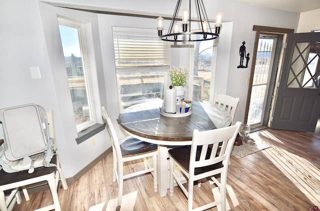 dining space with an inviting chandelier, light hardwood / wood-style flooring, and a wealth of natural light