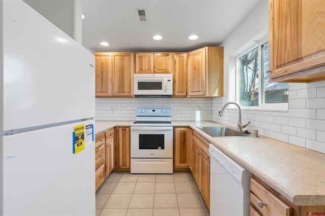 kitchen featuring white appliances, backsplash, light tile patterned flooring, and sink