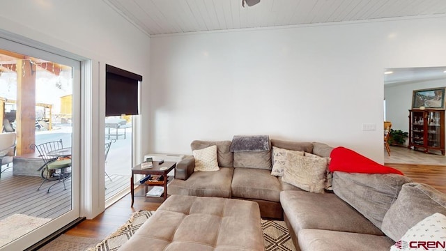 living room with wooden ceiling, crown molding, and hardwood / wood-style flooring