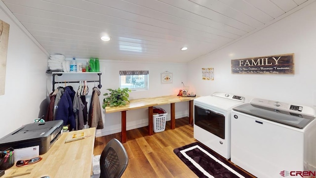 laundry room featuring washer and dryer, light wood-type flooring, and wood ceiling