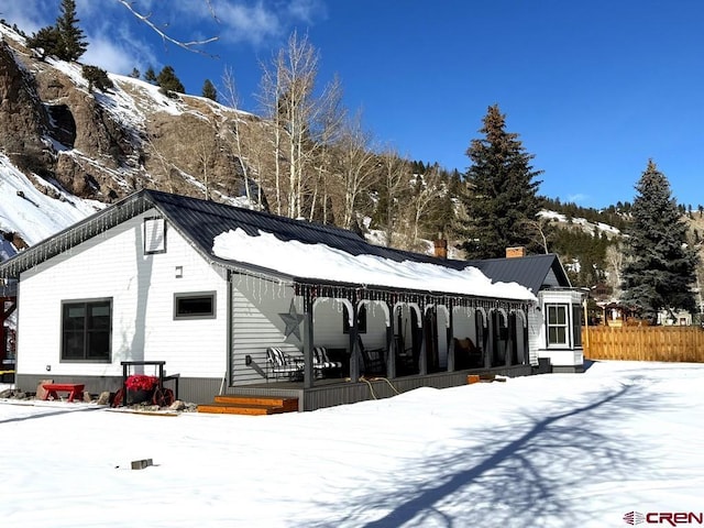 snow covered property with a mountain view