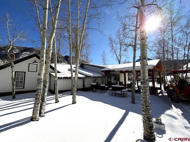 view of snow covered rear of property