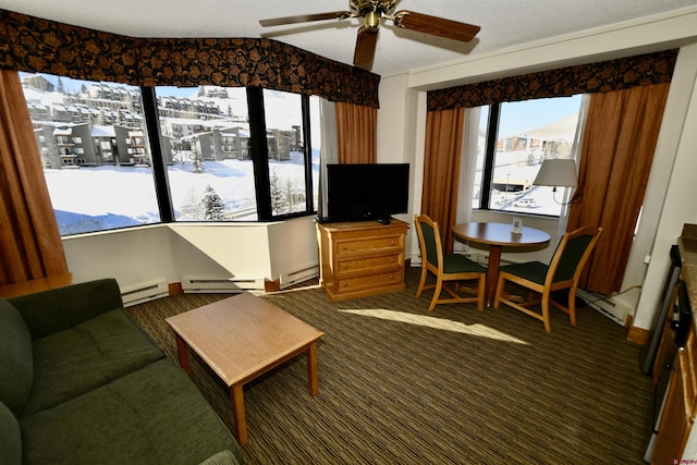 interior space with ceiling fan, a baseboard radiator, and dark carpet