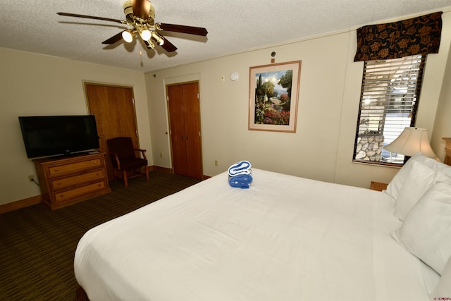 carpeted bedroom with ceiling fan and a textured ceiling