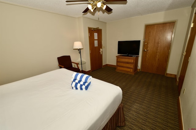 carpeted bedroom featuring a textured ceiling and ceiling fan