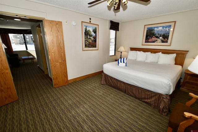 carpeted bedroom with ceiling fan and a textured ceiling