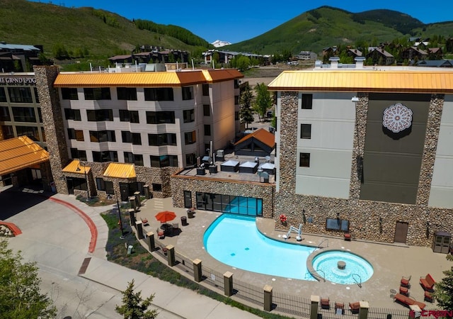 view of pool with a patio and a mountain view