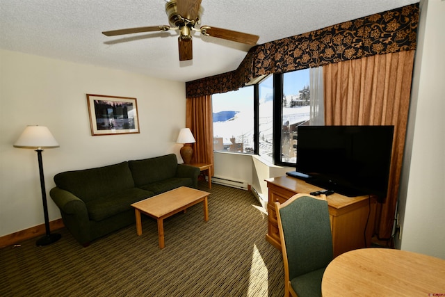 carpeted living room featuring a textured ceiling, ceiling fan, and a baseboard radiator