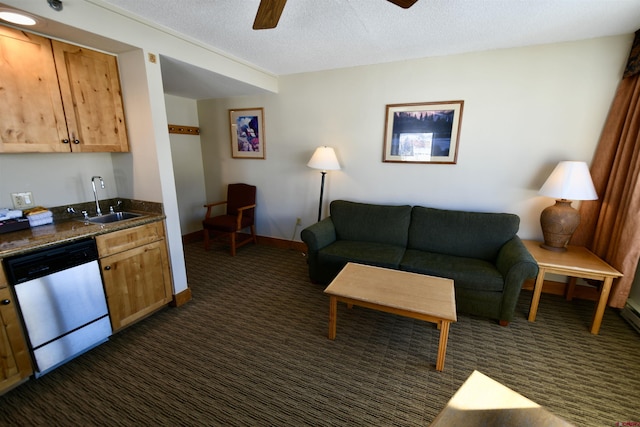 living room featuring sink, ceiling fan, a textured ceiling, and dark colored carpet